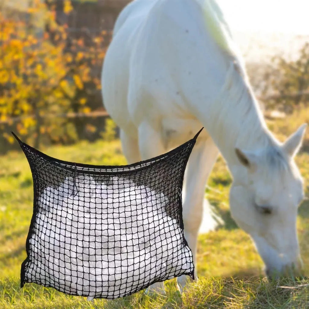Woven grid horse feeding bag hanging with hay, shown in black colour