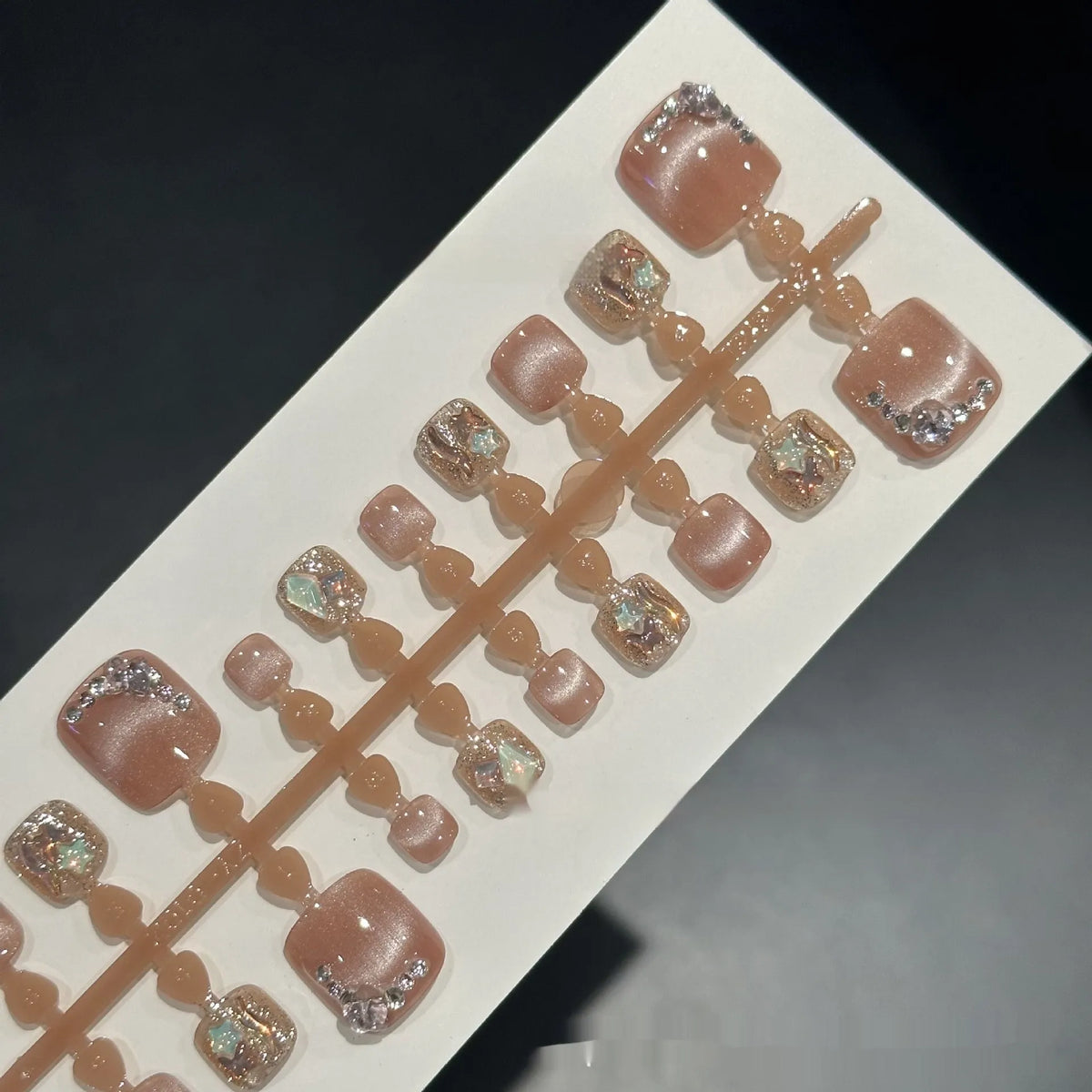 Nude cat eye toenail wear with hand-applied white diamond studs in a smiling pattern, 42 pieces in sizes S M L