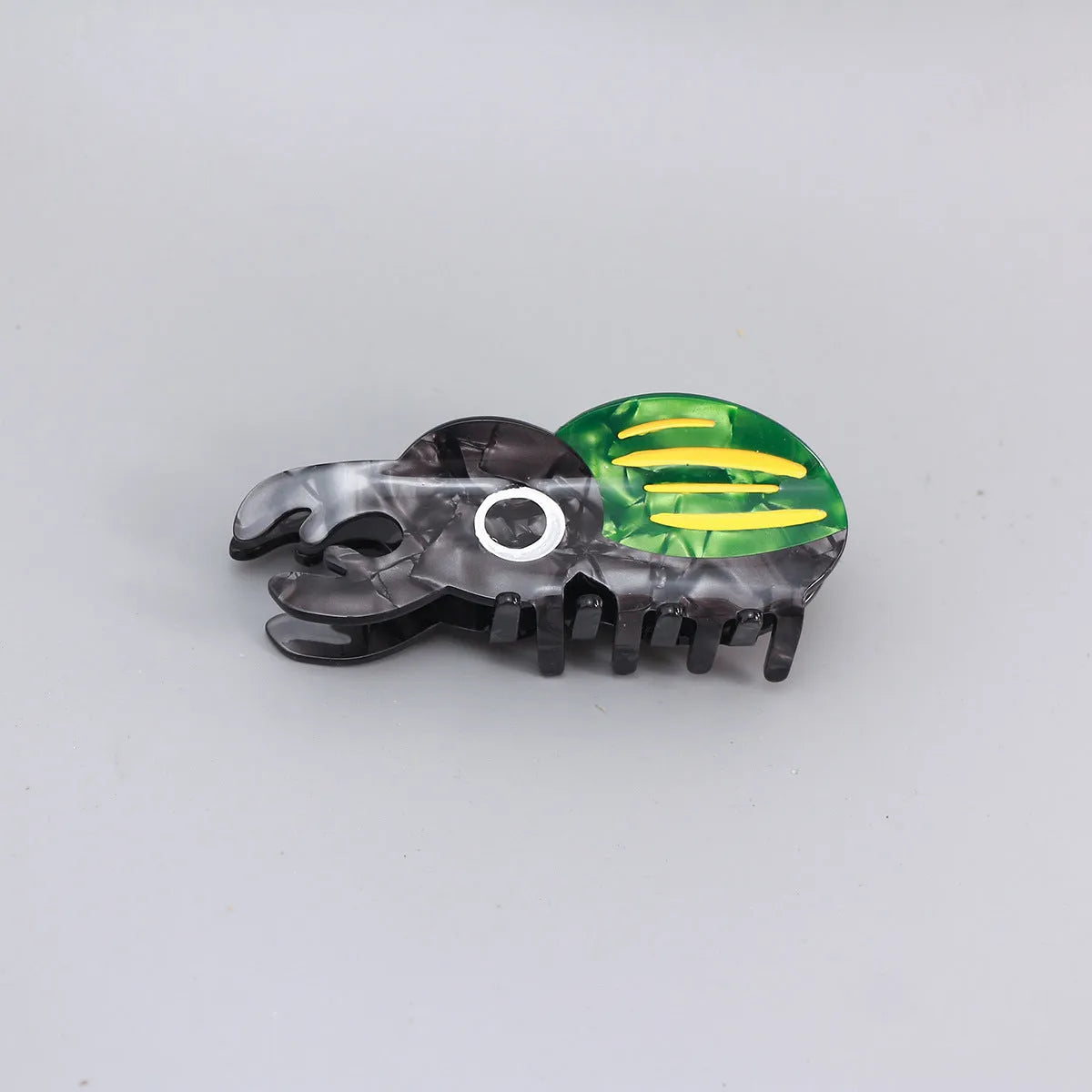 Handmade cartoon beetle grip brooch made from cellulose acetate in green, orange, or white insect designs.