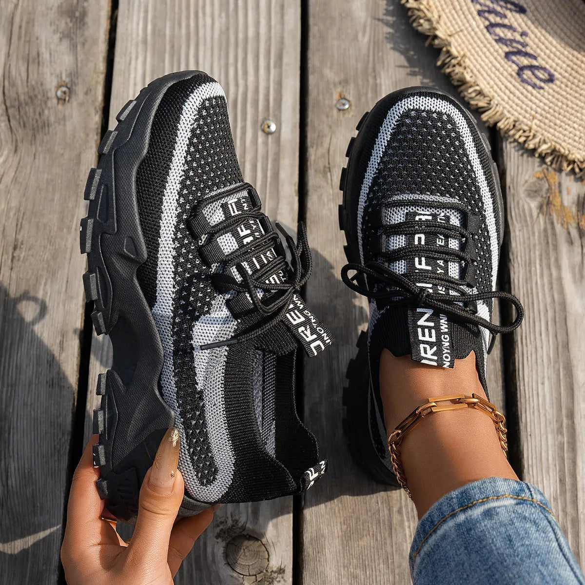 Women's Flyknit mesh lace-up sneakers in a colour option, showing the round toe and rubber sole.