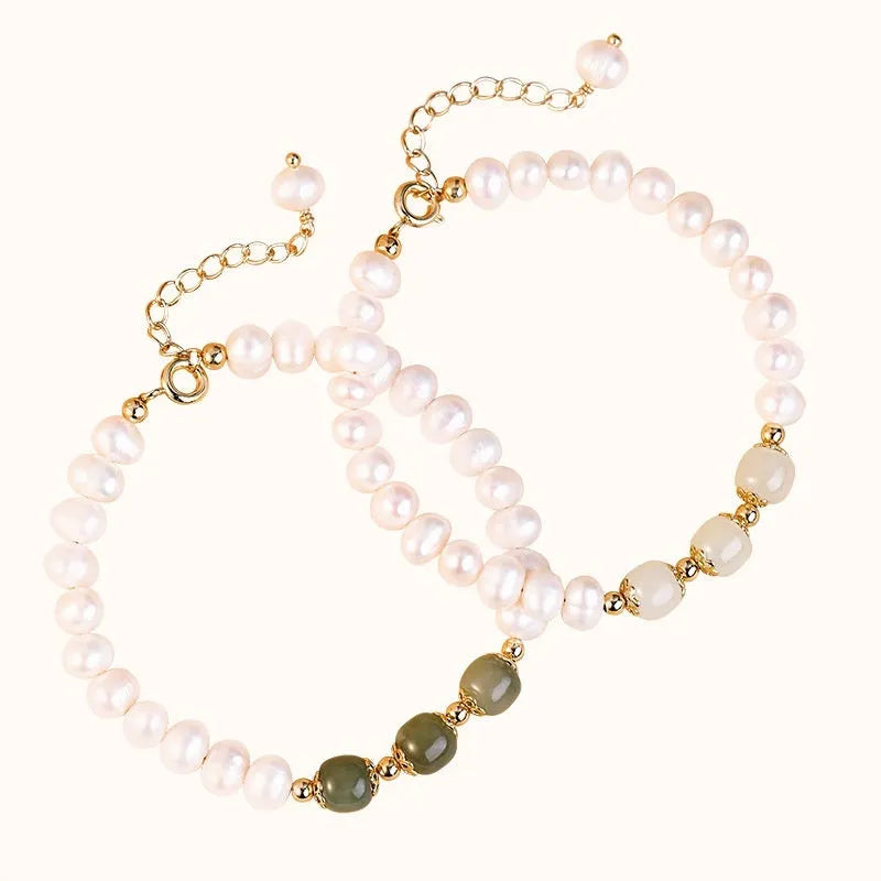 Natural freshwater pearl bracelet with diamond-shaped beads in Hetian jade colour on a wrist.