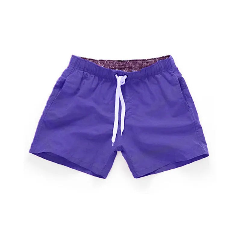 Men's polyester beach shorts in black, shown laid flat, featuring a straight leg opening.