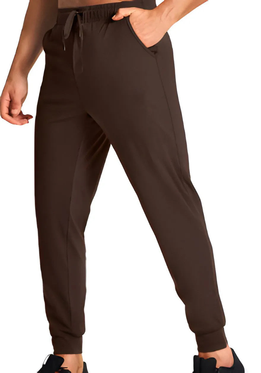 Man wearing loose fit solid colour casual polyester trousers in a leisure setting.