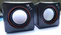 Small black square 2.0 computer speaker with USB power cable for desktop and laptop use.
