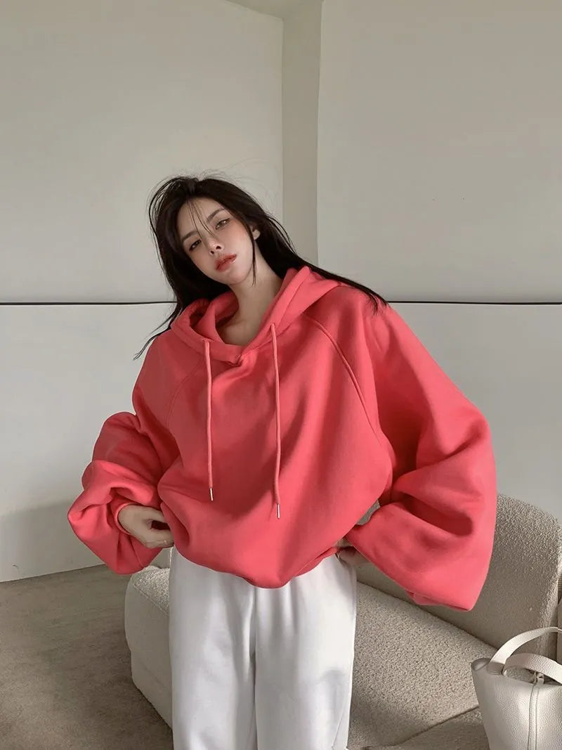 Watermelon red women's mulberry silk hooded sweater with sleeveless design on hanger