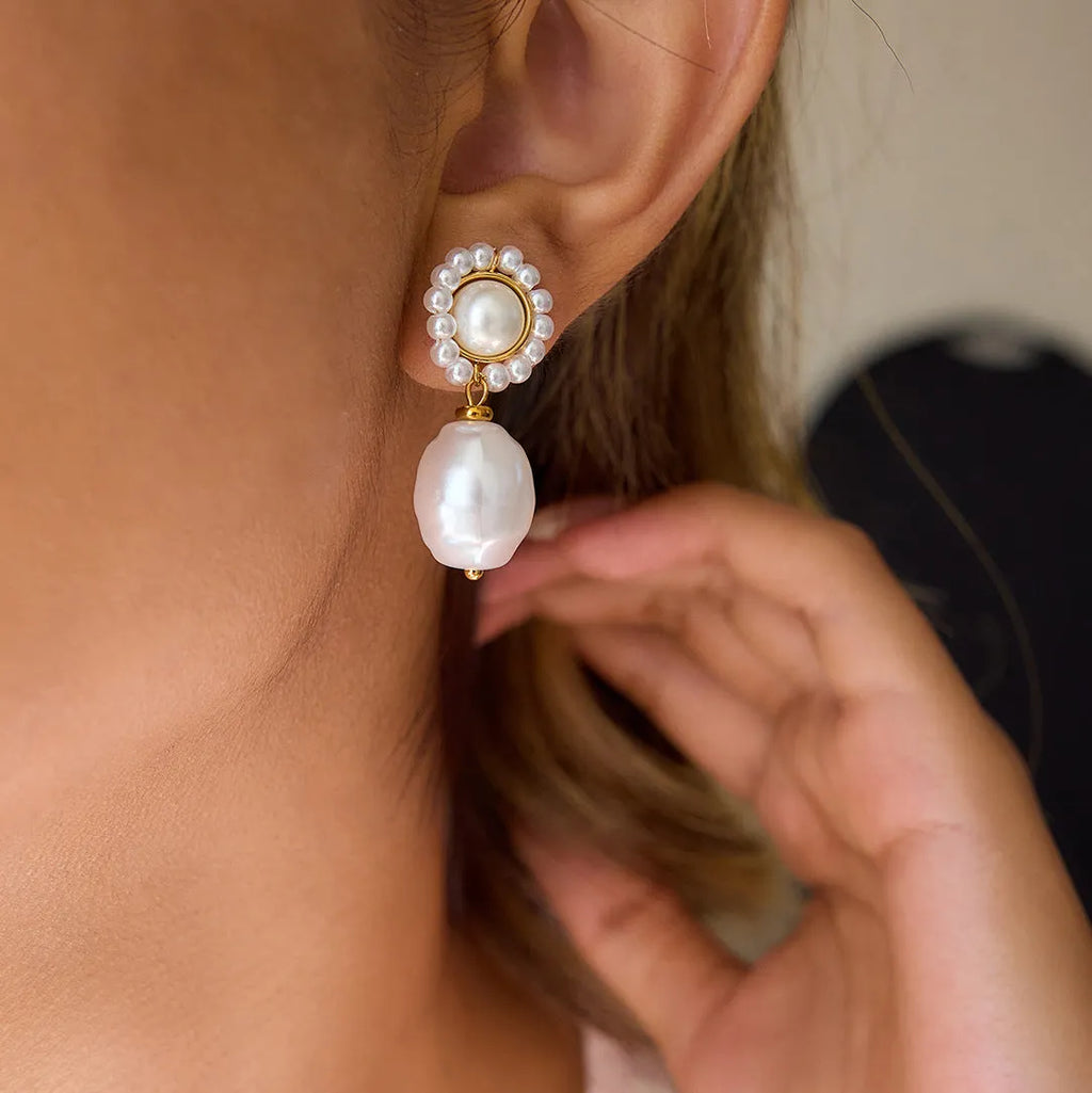 Women's stainless steel pearl ear studs with geometric ellipse shape and electroplated silver-tone finish