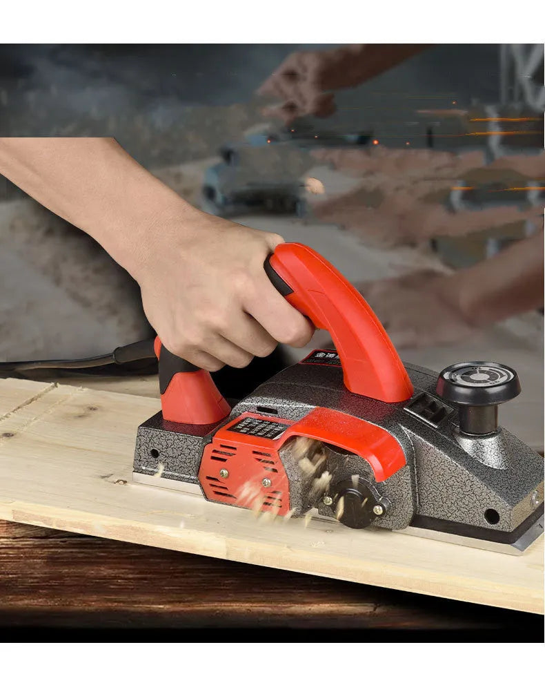 Red household desktop electric push planer tool with aluminium shell for woodworking.