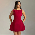 Woman wearing a sleeveless high-waist backless mini dress in black polyester fabric
