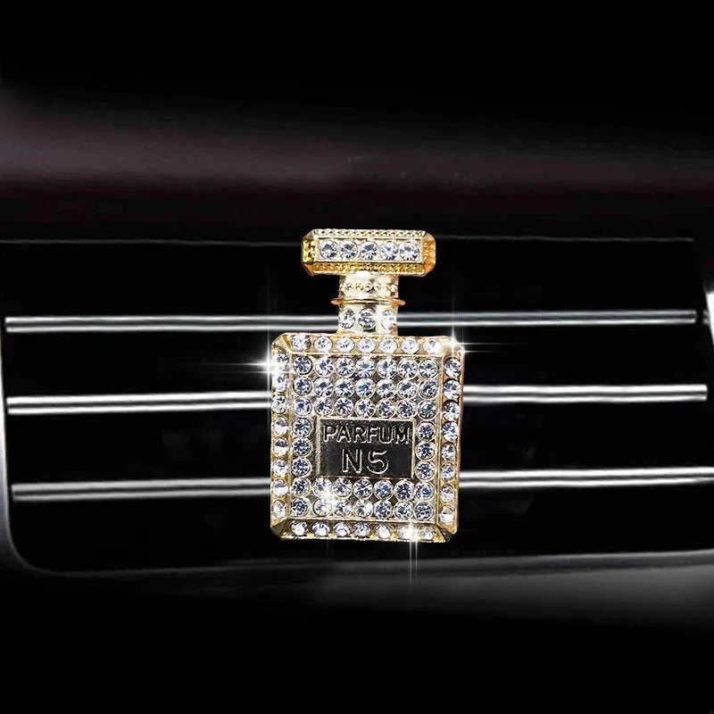 Gold alloy car air freshener holder in perfume bottle style, approx. 4.7cm x 3cm, for fragrance tablets