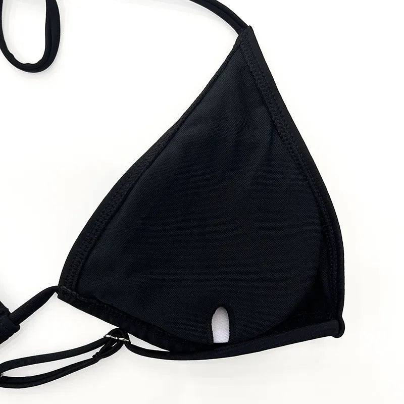 Black mesh long sleeve four-piece bikini set for women, laid flat showing top and briefs.