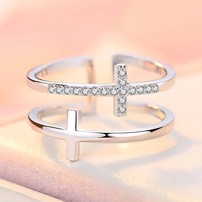 Adjustable copper women's ring with double cross design, zircon stones, and sterling silver inlay in white gold finish.