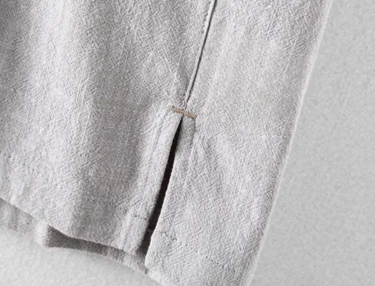 Man wearing a loose-fitting light grey linen casual shirt for leisure.