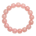 Natural crystal barrel shaped bead bracelet with pink polished geometric beads
