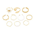 Gold coloured openwork flower design ring for women on a white background.