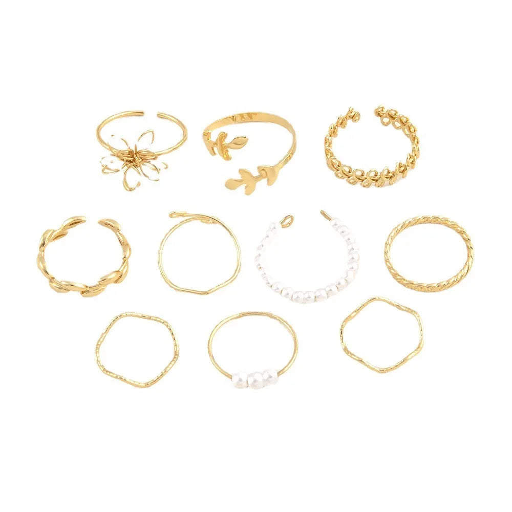 Gold coloured openwork flower design ring for women on a white background.