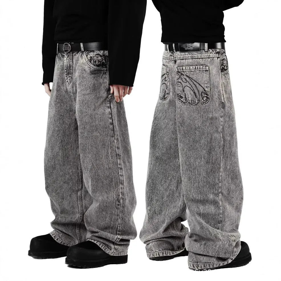 Grey loose straight-leg denim trousers on hanger showing mid-rise waist and cotton denim fabric