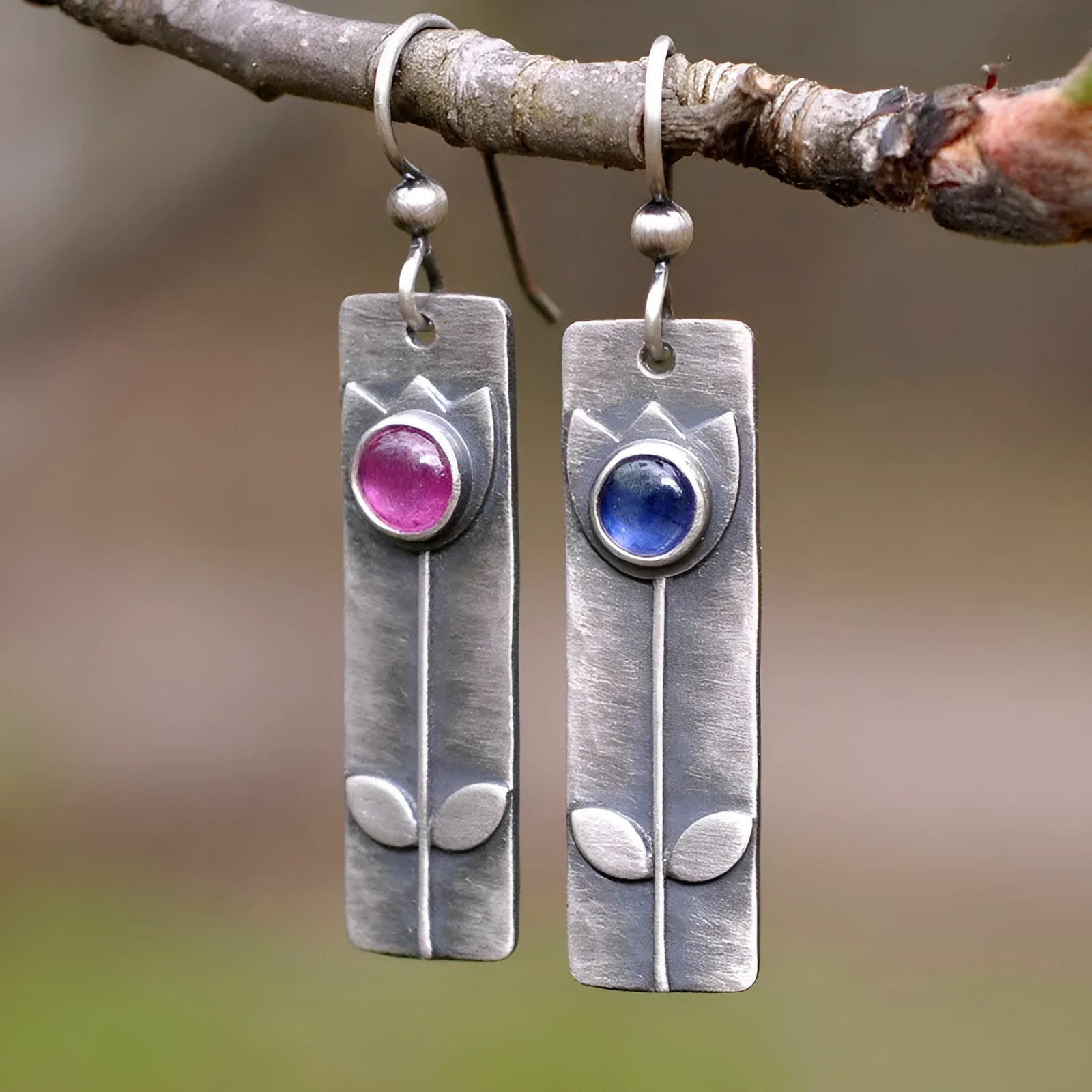 Geometric antique finish red sapphire earrings with elliptical elements and electroplated metal construction
