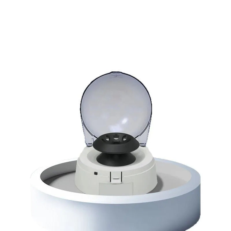 Compact white mini laboratory centrifuge on a bench-top with display showing 7000 rpm.