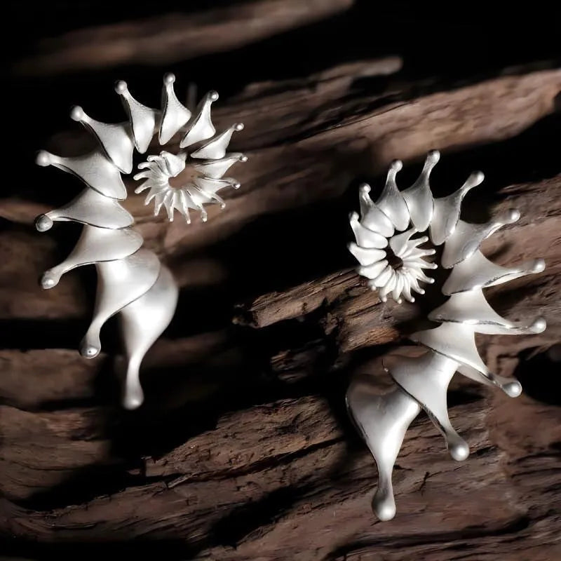 Matte finish conch stud earrings with three-dimensional shaping and irregular design elements