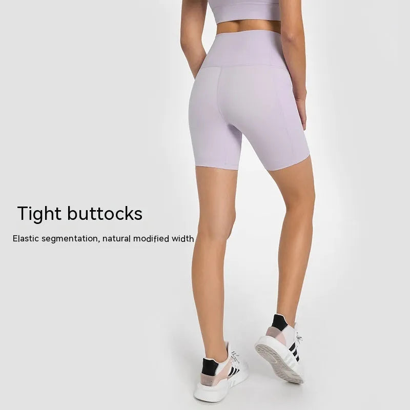 Woman wearing solid colour super stretch cotton blend sports shorts for running.