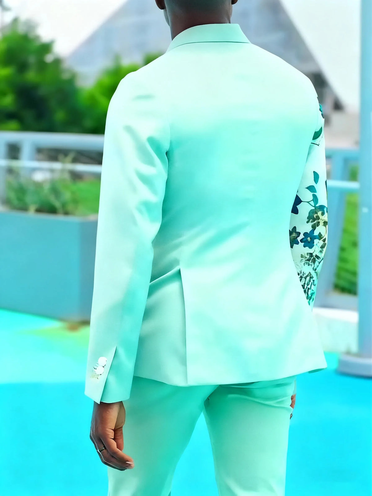 Mint green double-breasted suit set with floral print sleeve and ankle-length trousers.