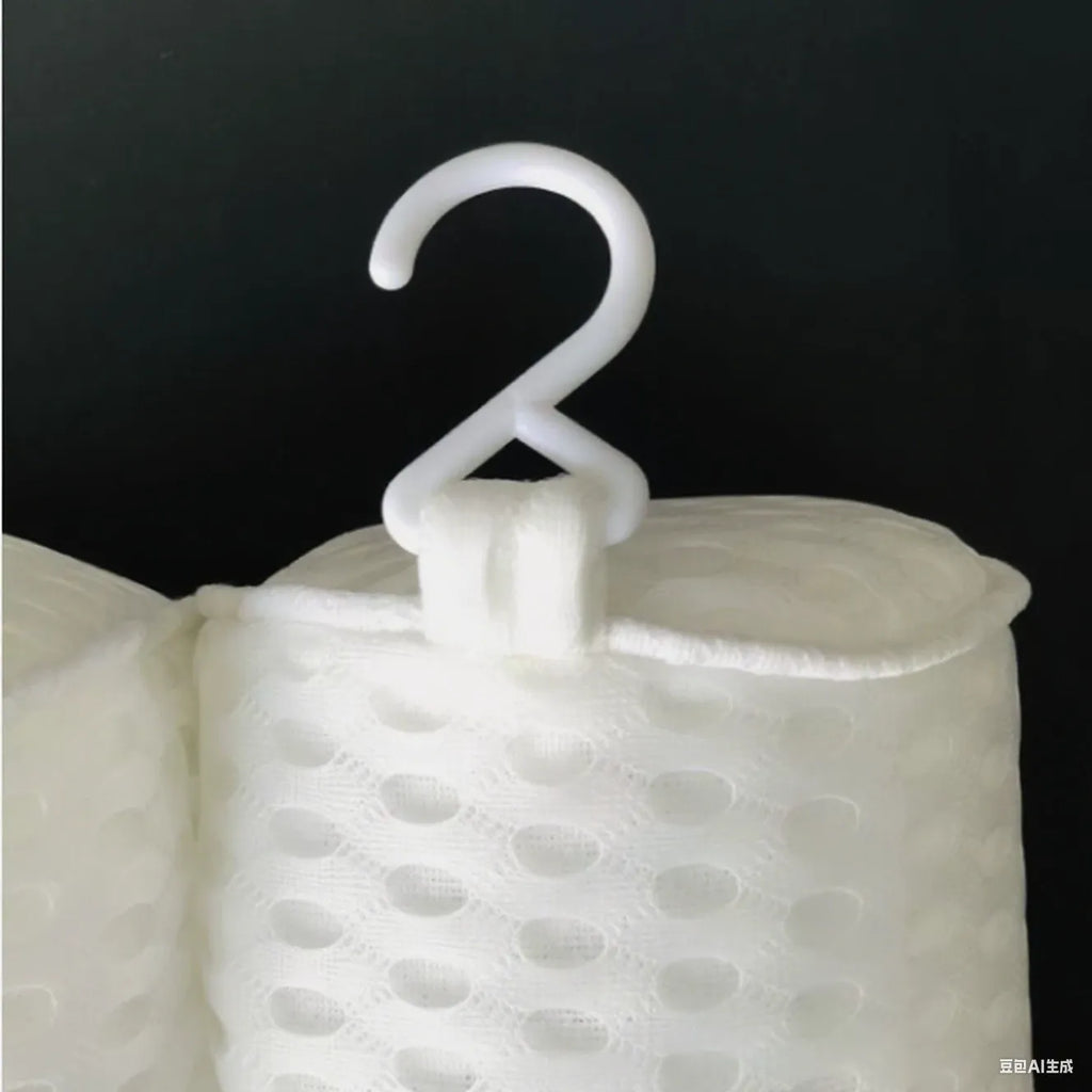 White bathtub pillow with 4D mesh and seven suction cups on a bath mat.