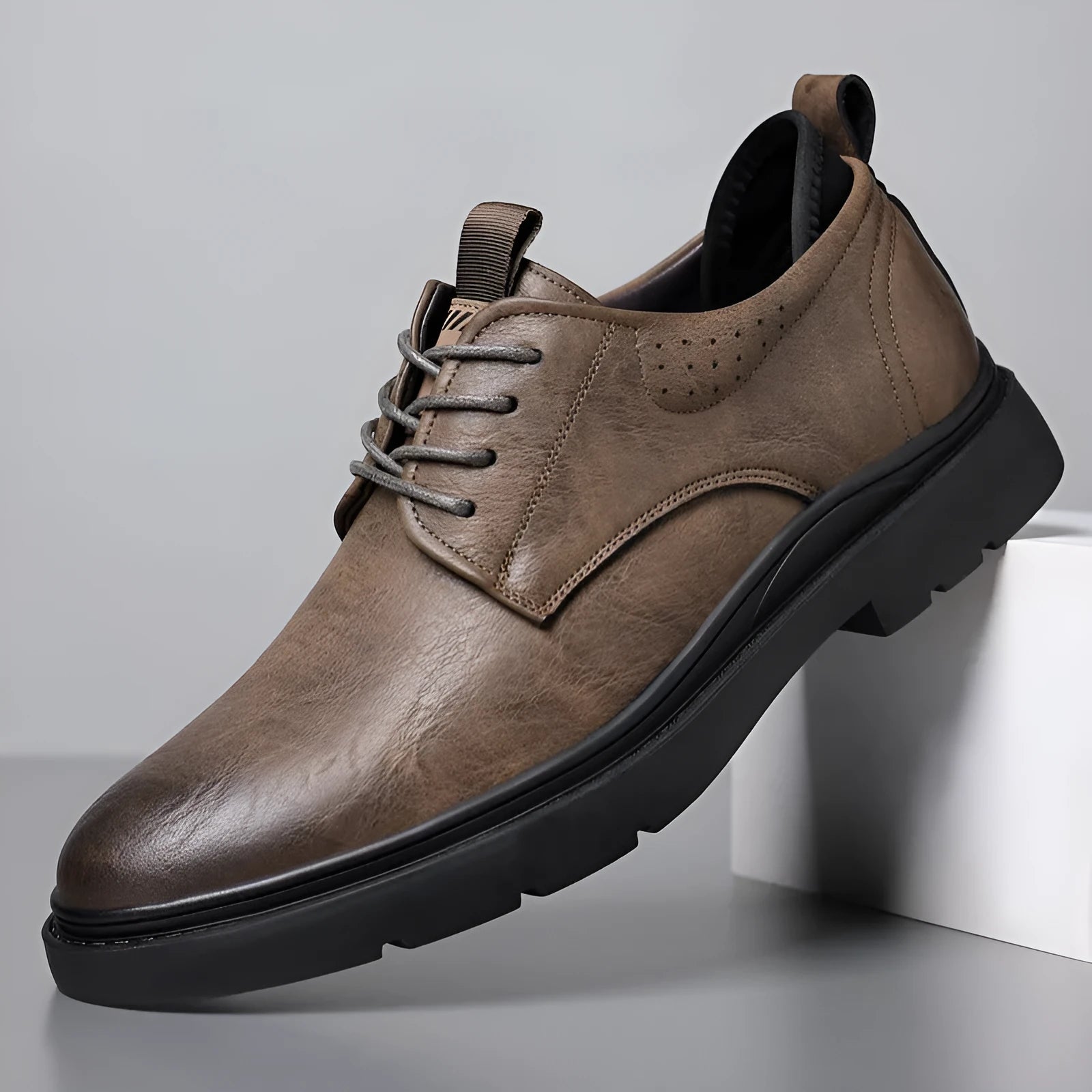 Men's black and brown leather shoes with sewn detailing and rubber sole