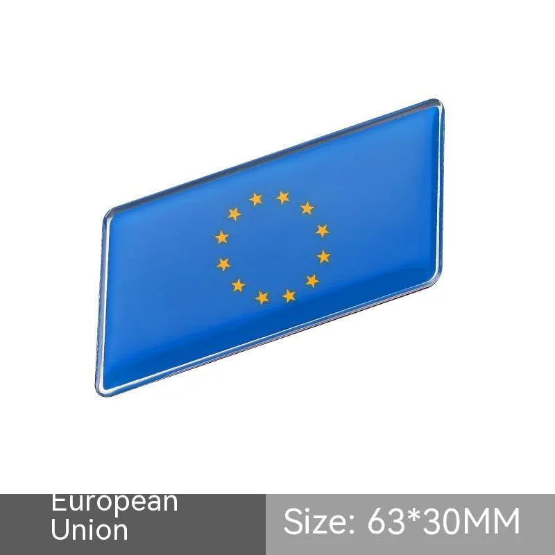 Aluminium national flag car sticker in a parallelogram shape measuring 6.3 by 3 centimetres.
