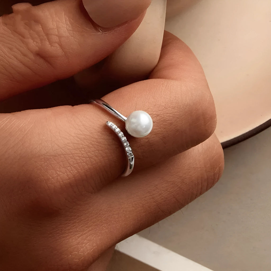 Sterling silver adjustable pearl ring with open loop design showing natural shell pearls on S925 silver band