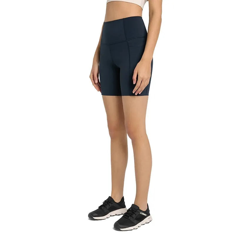 Woman wearing solid colour super stretch cotton blend sports shorts for running.