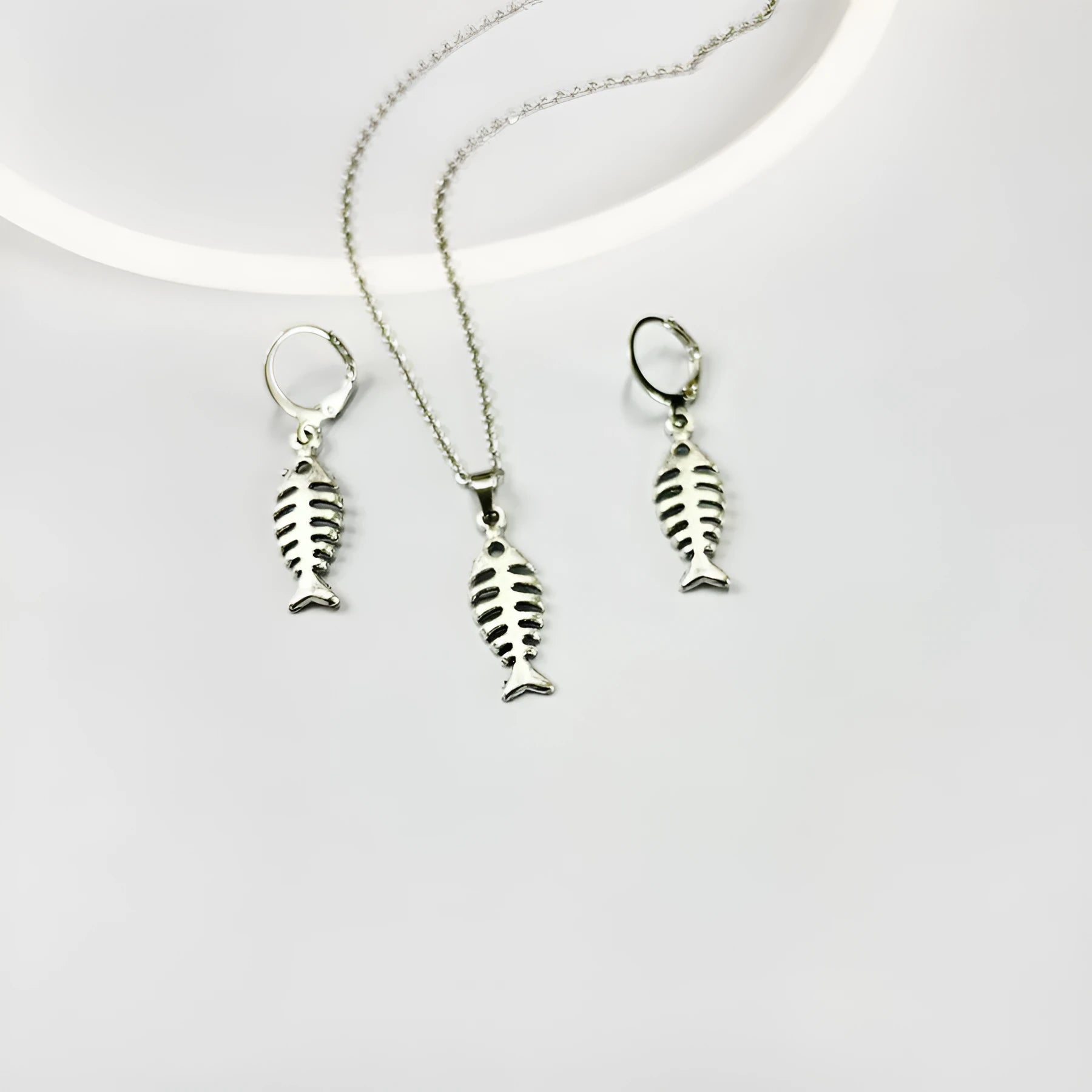 Women's retro-style alloy fishbone pendant necklace and matching earrings set on a white background