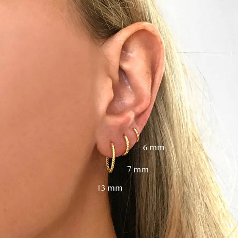 Twisted string round ring earrings in sterling silver with geometric design showing gold and platinum finish options