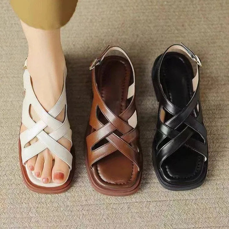 Women's patent leather low heel square toe beach sandals in black colour with cross strap design