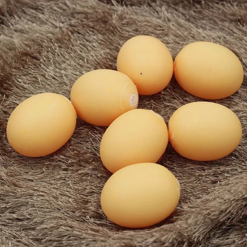 Red and white egg-shaped dog chew toy with textured surface and built-in squeaker