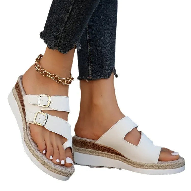 White woven patent leather women's wedge sandals with peep toe and finger-fit design on a neutral background.