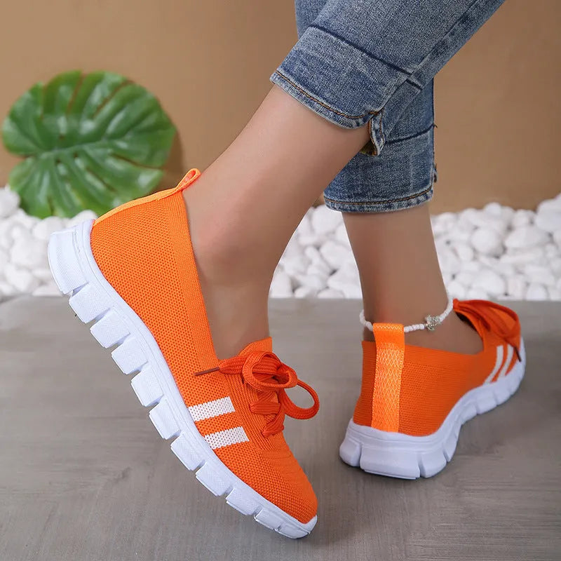 Women's lace-up mesh trainers with flat rubber sole, round toe and shallow mouth, shown in grey, black, orange and brown