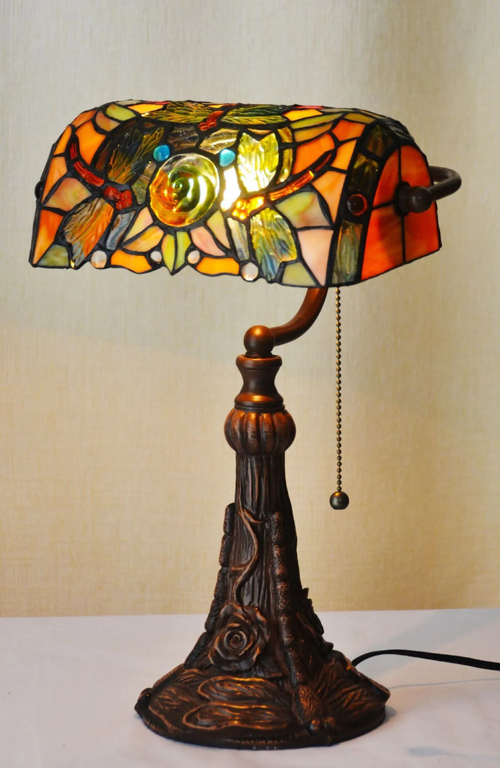 10-inch Tiffany stained glass table lamp with resin base on a desk.