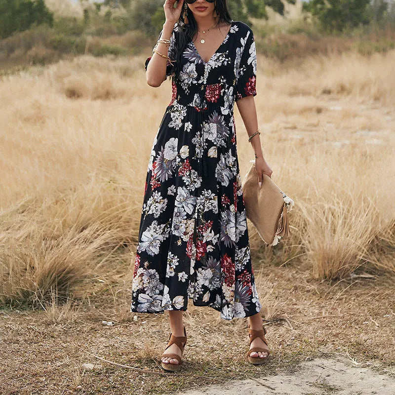Yellow floral print summer dress with V-neck, short sleeves, and an elastic high waist on a mannequin.