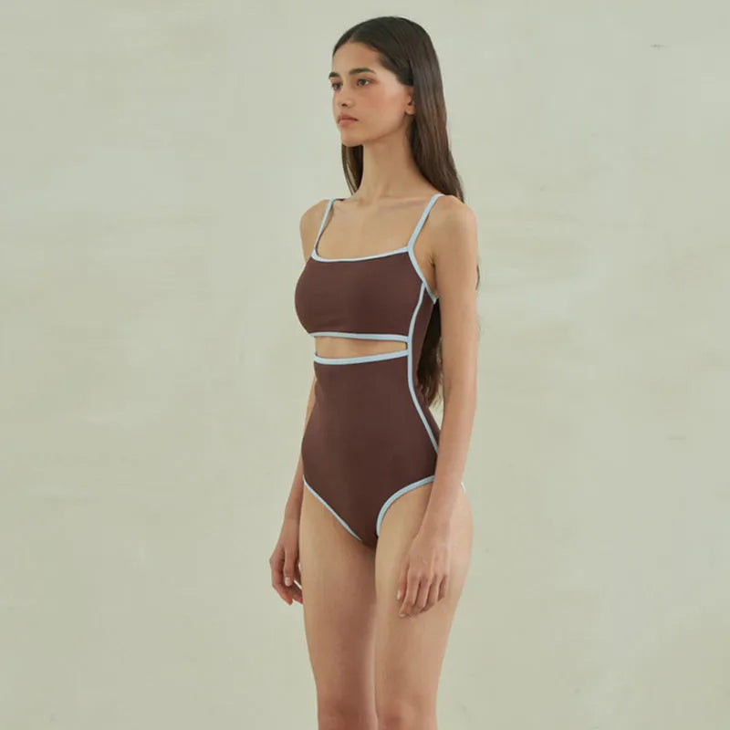 Brown women's one-piece swimsuit with a triangle top on a mannequin