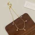 Women's zircon jewellery set showing necklace, earrings and anklet with geometric meteor shower design