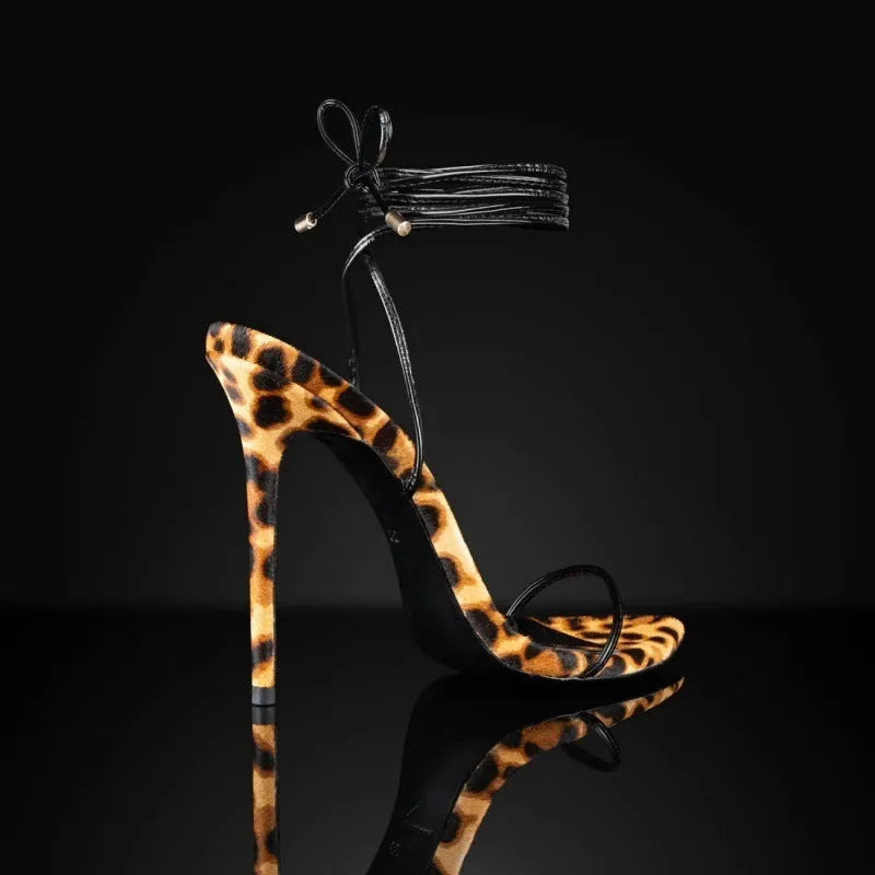 Women's leopard print Roman sandals with pointed toe and lace-up buckle design.