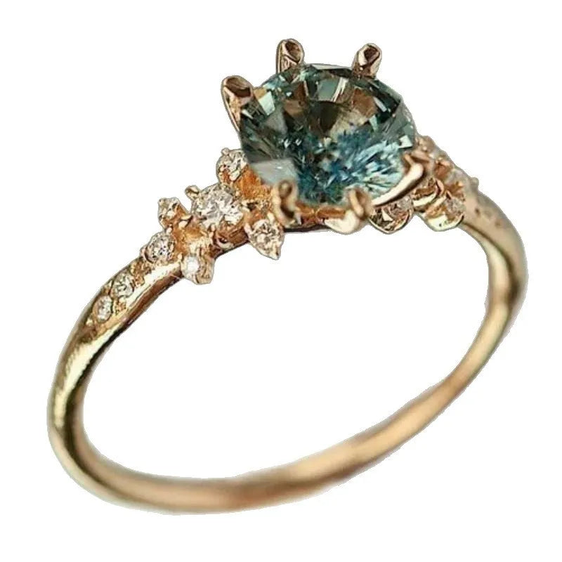Gold-coloured geometric claw ring with a chamfered square design and a set zircon stone.