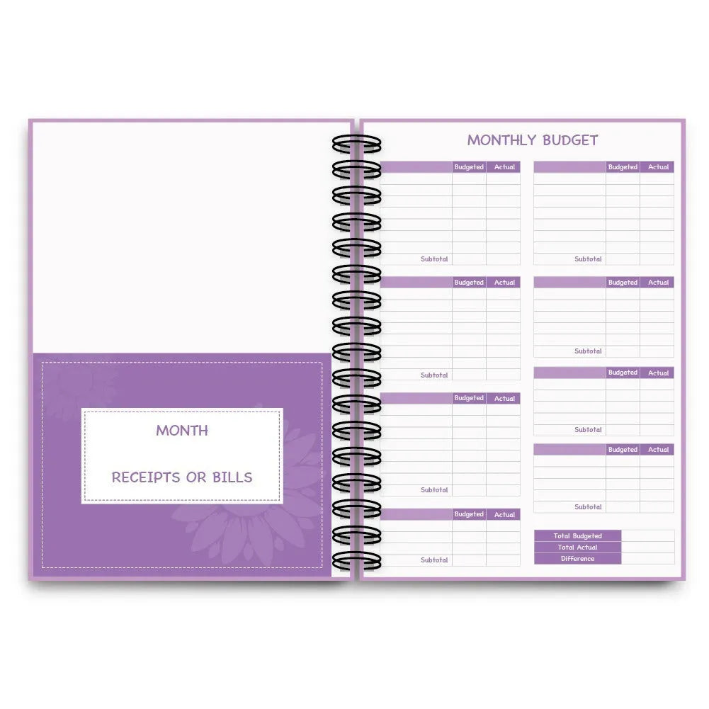 Purple coil-bound budget notebook with pen and stickers for financial planning