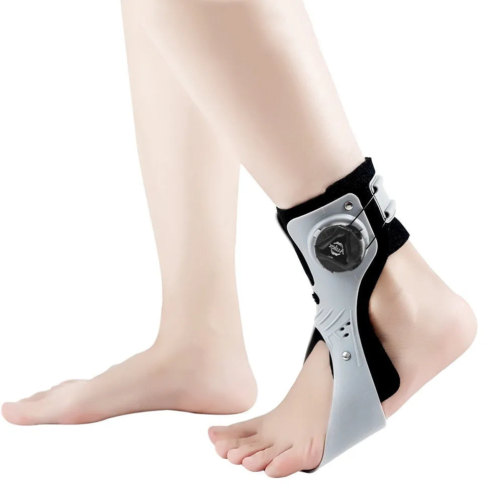 Grey and black ankle fixation brace with airbag button support mechanism for training and rehabilitation