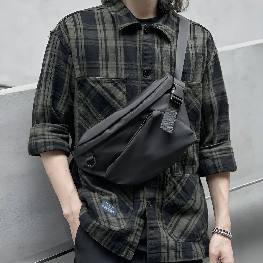 Black men's Oxford fabric chest bag with visible stitching, worn across the chest.