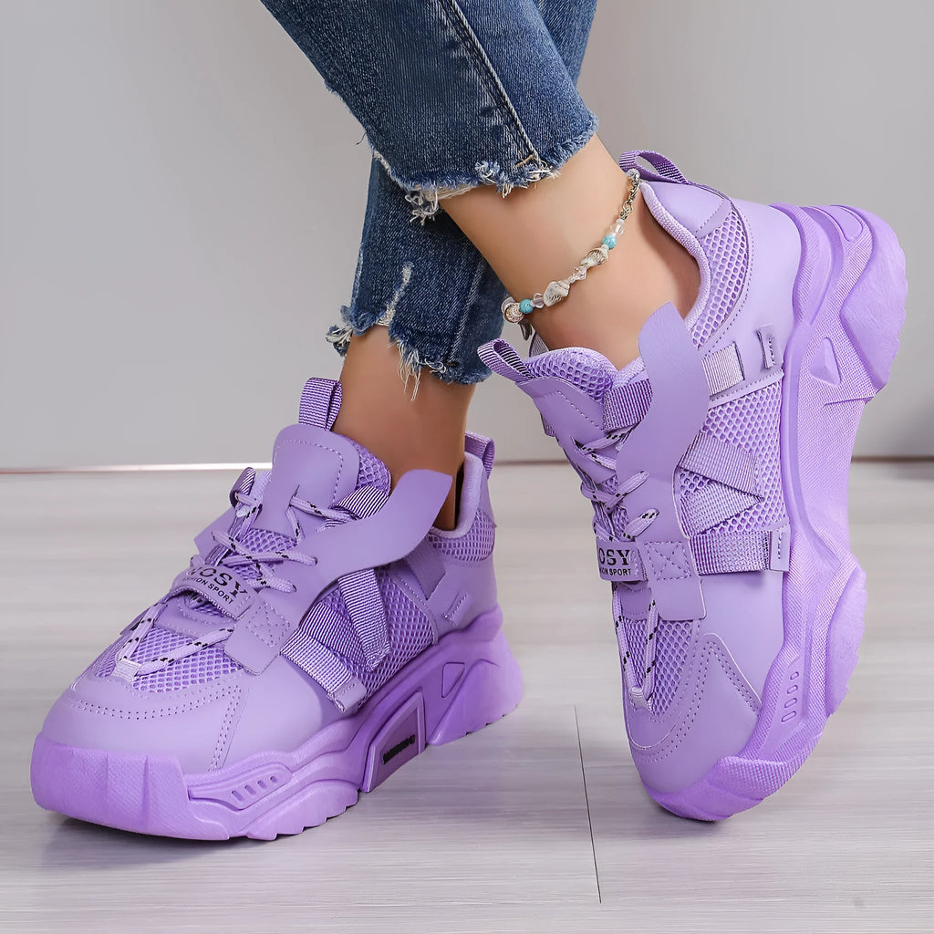 Women's purple platform sneakers with breathable mesh upper and white sole on a plain background.