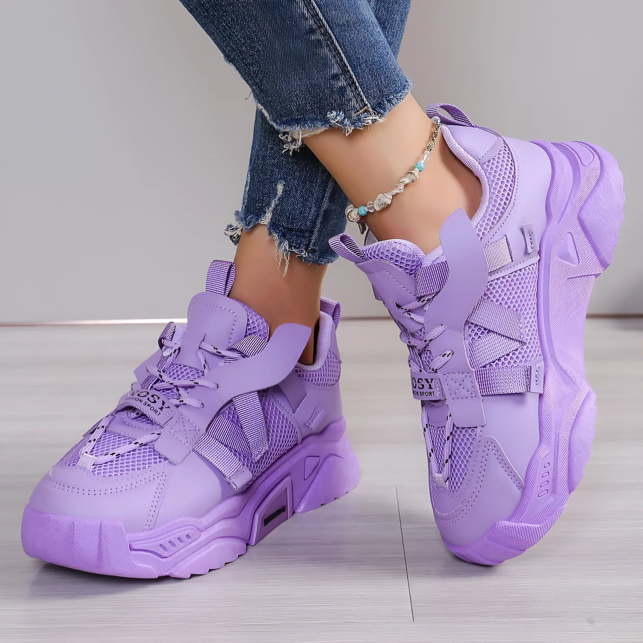 Women's purple platform sneakers with breathable mesh upper and white sole on a plain background.