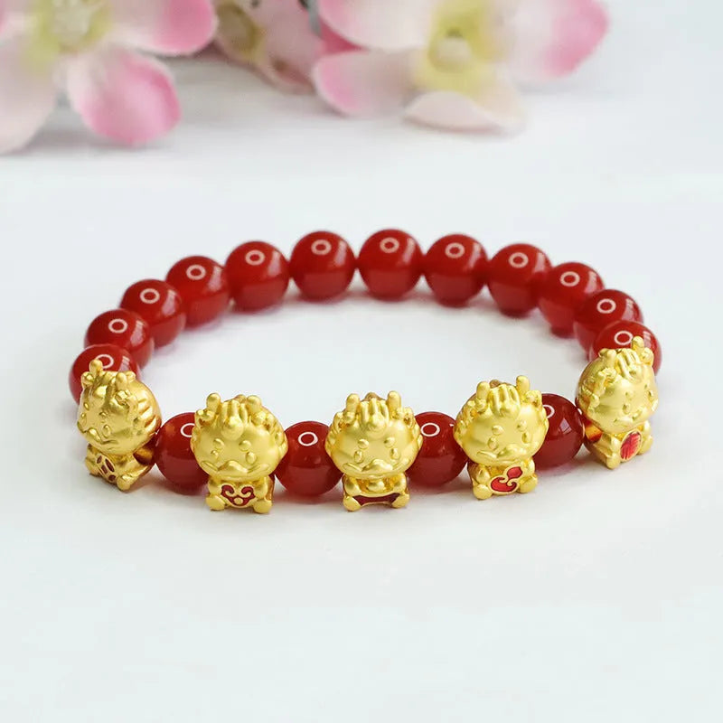 Close-up of a red agate bracelet with a carved five blessing dragon motif on 8mm beads.
