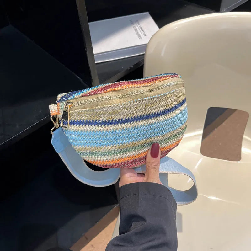 Women's blue bohemian straw beach bag with shell shape and single shoulder strap showing woven construction