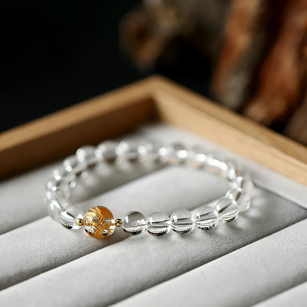 Geometric obsidian black agate and white crystal bracelet with golden dragon bead on adjustable cord.